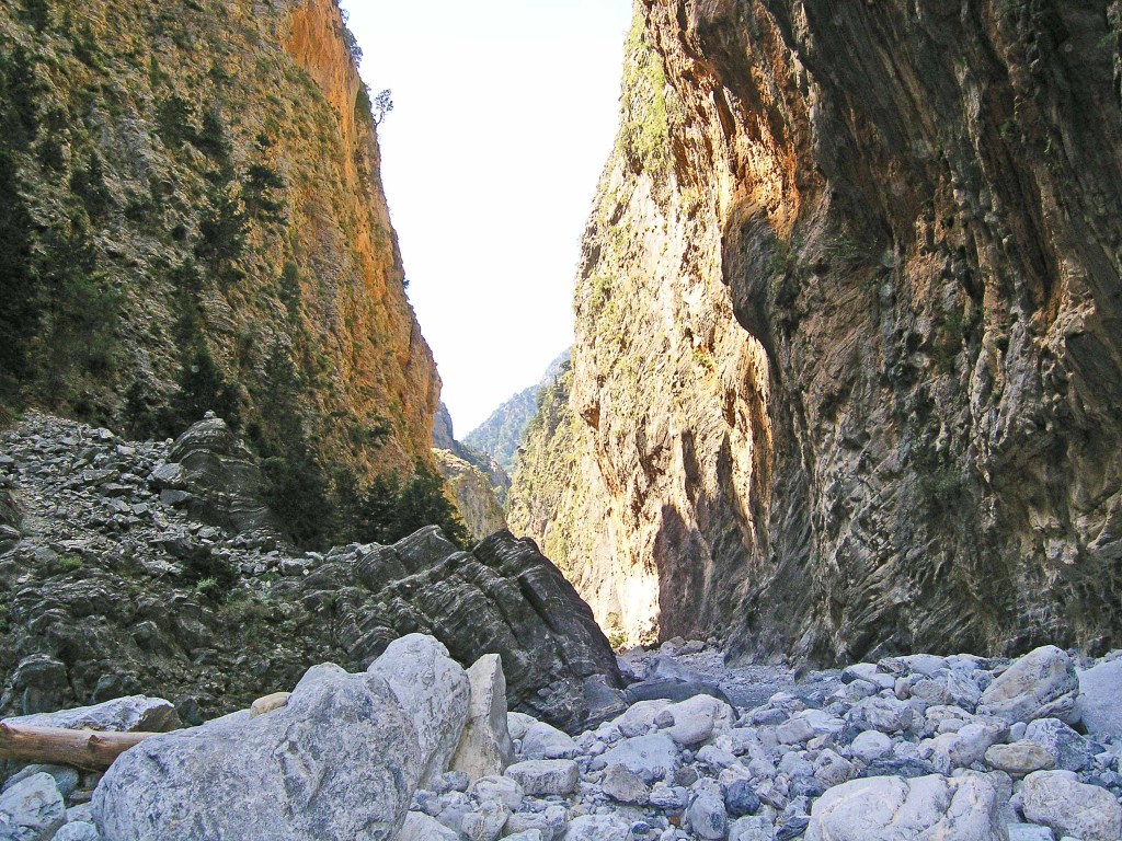 Towering mountain walls with white rocks in the foreground